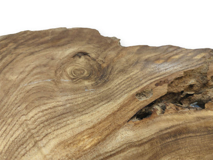 A timber piece shows a spiraling knot and a rough, cavernous void in its grain.