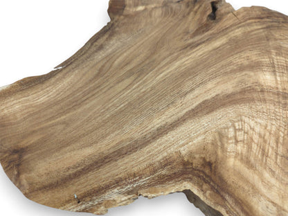 Bands of light and dark grain flow diagonally across a smooth, raw-edged timber section.