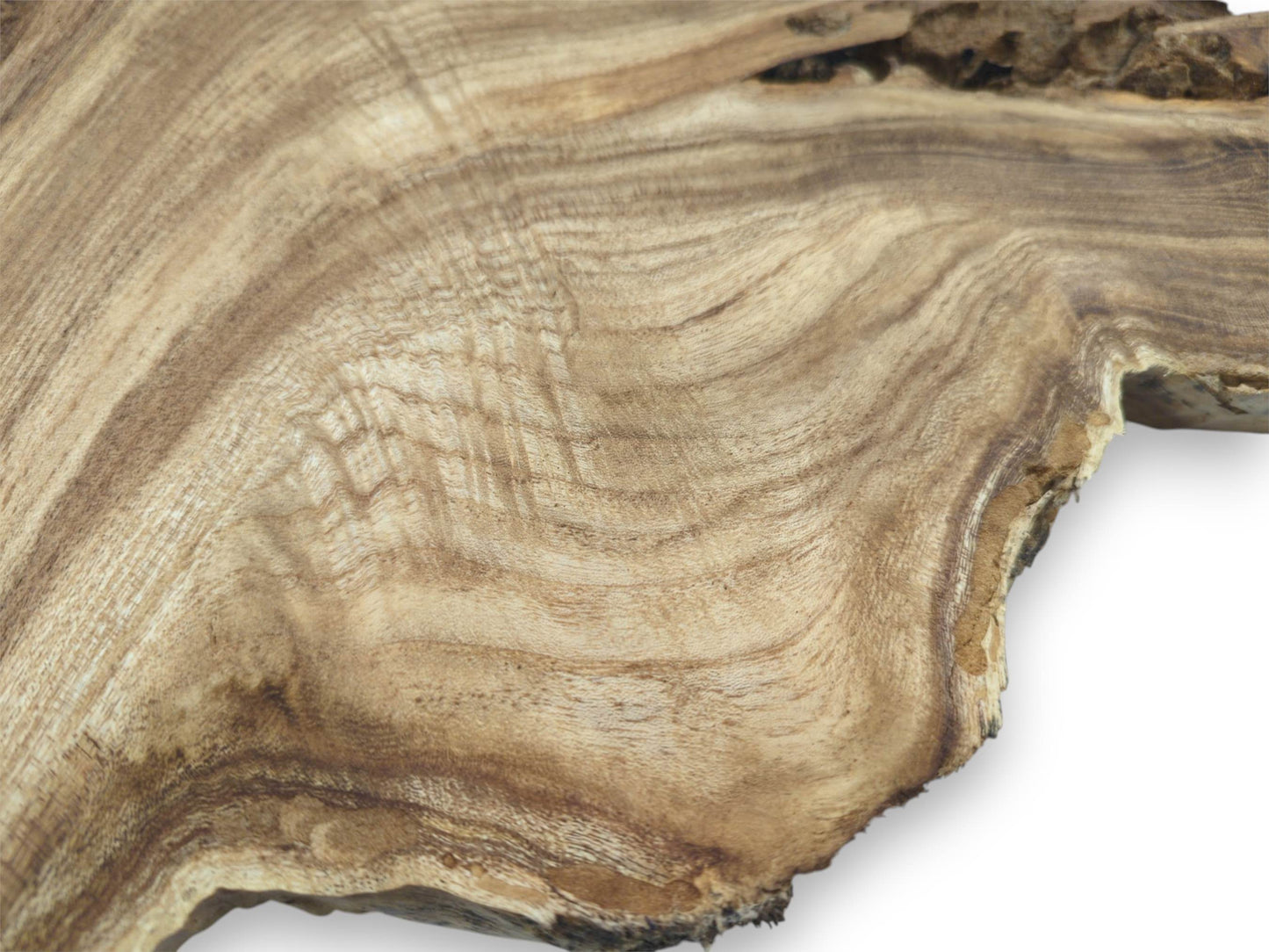 Contoured waves of light and dark grain ripple across a timber slab's raw surface.
