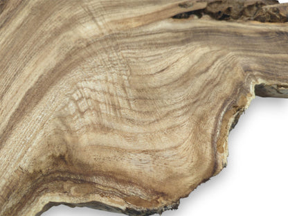Contoured waves of light and dark grain ripple across a timber slab's raw surface.