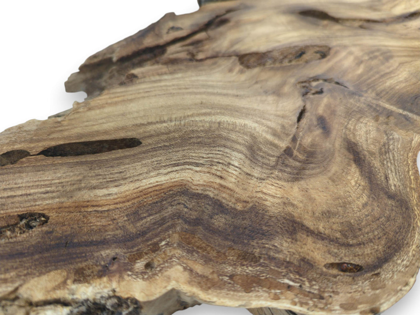 A close perspective captures fine, undulating grain and dark, narrow voids on a timber slab.