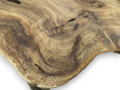 A high-angle view details the flowing, dual-toned grain and a dark crack on the timber's surface.