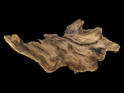 Flowing, topographic grain patterns ripple across a raw timber slab with an irregular, rough edge.