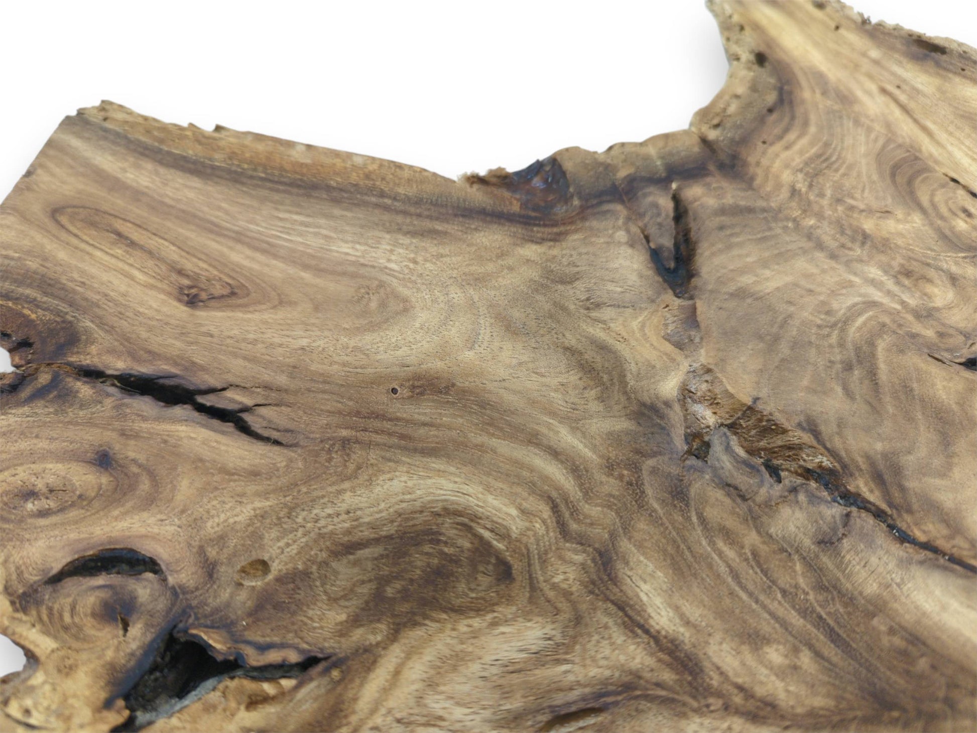 Dark, branching fissures cut through the swirling, topographic grain of a finished timber section.