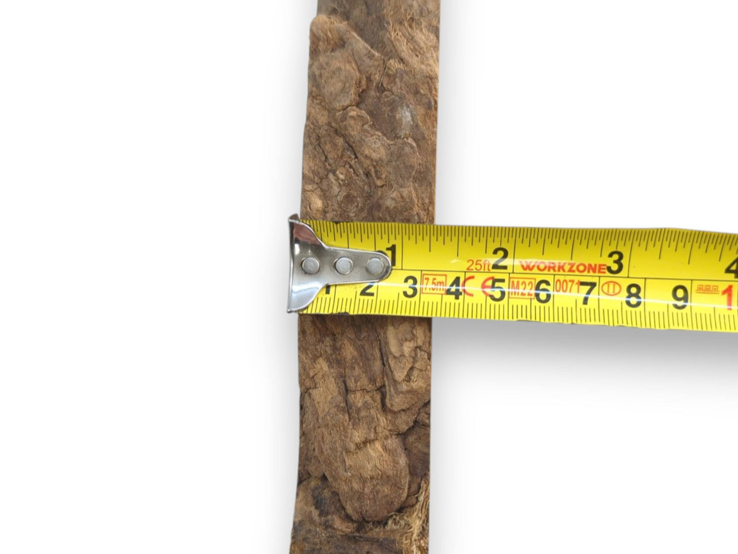 A yellow measuring tape crosses a vertical timber section with a rough, craggy bark texture.