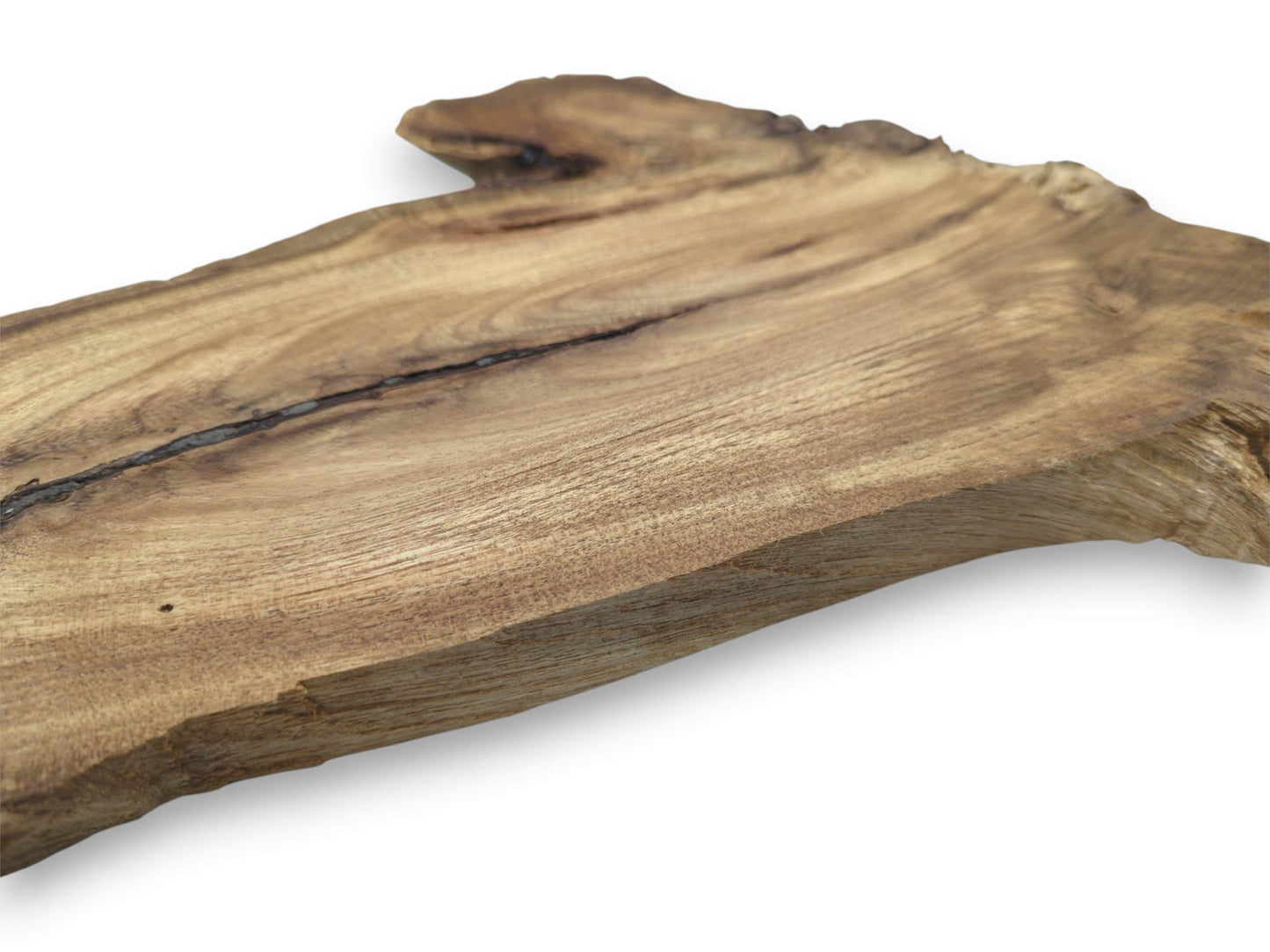 An angled perspective on a finished lumber plank highlights a dark fissure and fine grain.