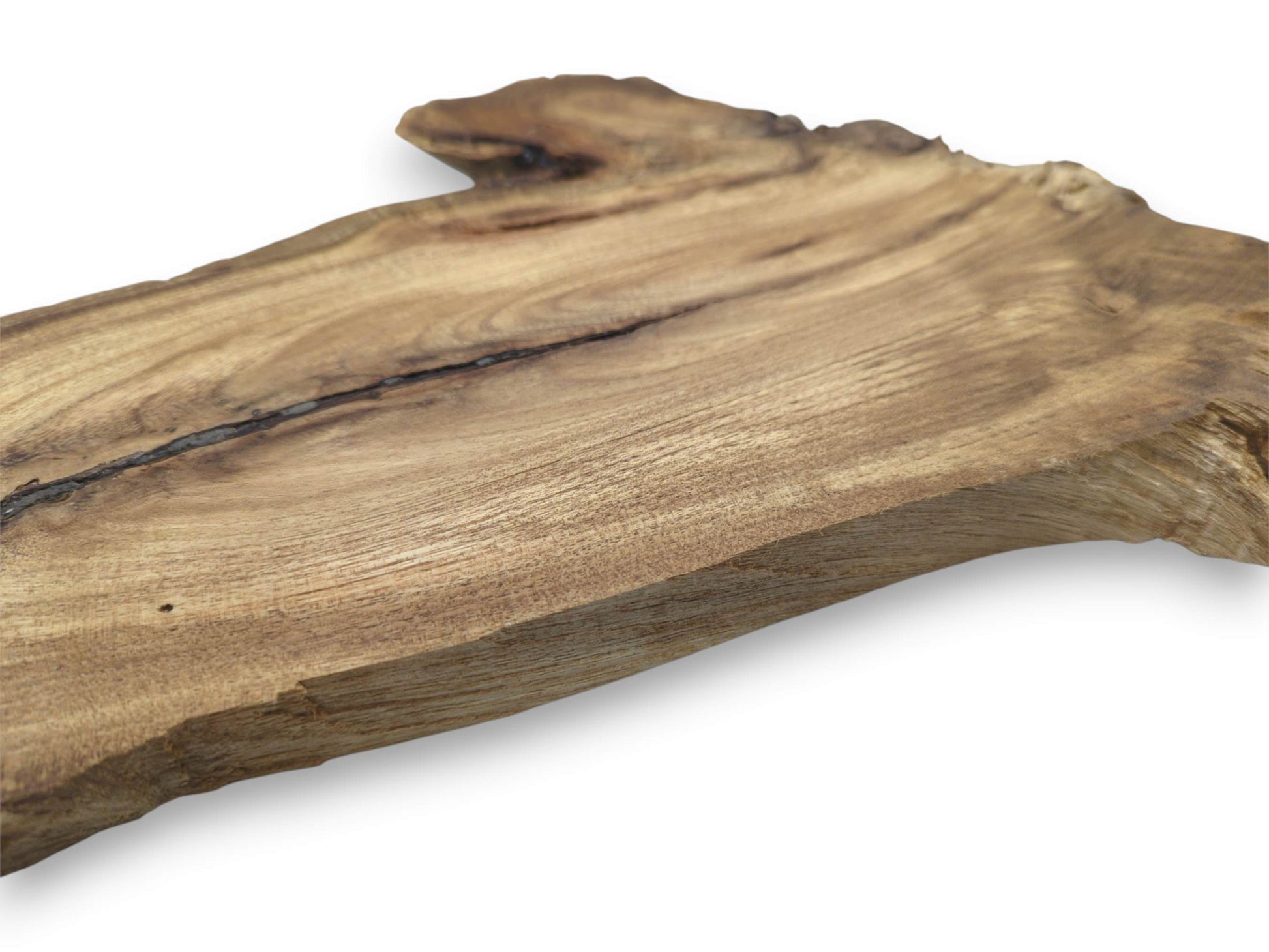 An angled perspective on a finished lumber plank highlights a dark fissure and fine grain.