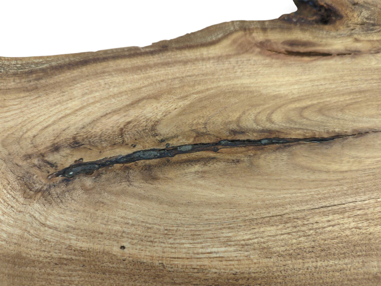 A dark, linear inclusion cuts across the undulating surface of a light-brown wooden board.