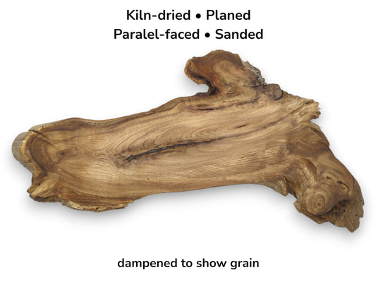 An overhead view of a rustic timber section reveals undulating grain and a dark central fissure.