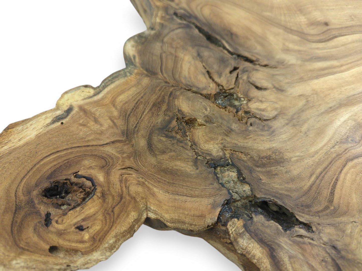 A dark, hollow knot and a deep central fissure interrupt the swirling grain of a wood slab.
