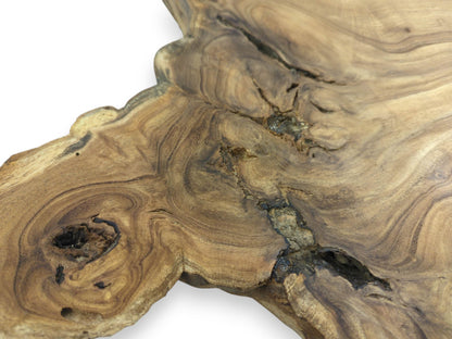 A dark, hollow knot and a deep central fissure interrupt the swirling grain of a wood slab.