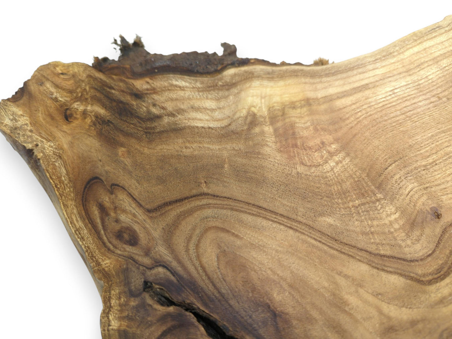 Dark, contoured growth rings flow across a smooth wood plank with a coarse bark edge.