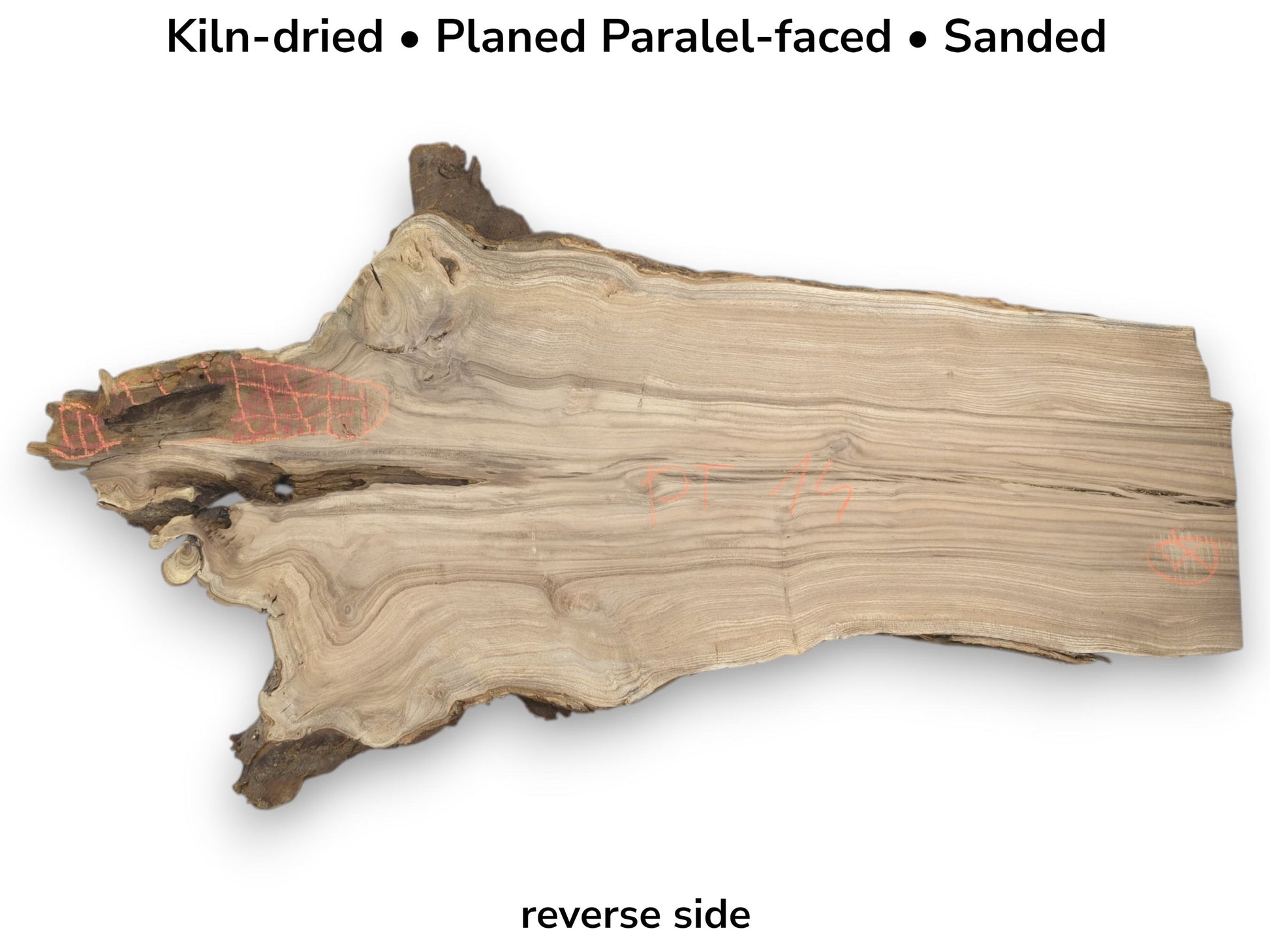 A planed timber piece shows wavy grain, a rugged bark edge, and pink chalk notations.