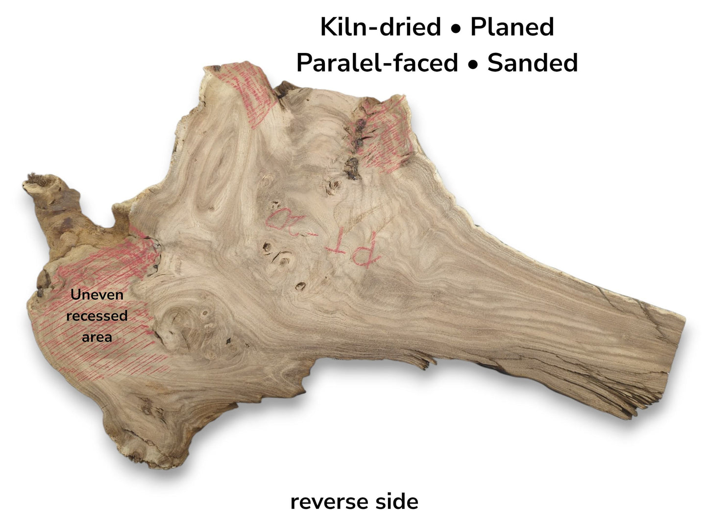 The reverse side of a planed hardwood slab with swirling grain and red-marked recessed areas.