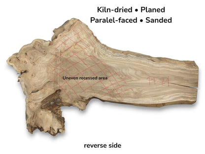 A raw wood plank with a knotty burl is marked with red crayon cross-hatching.