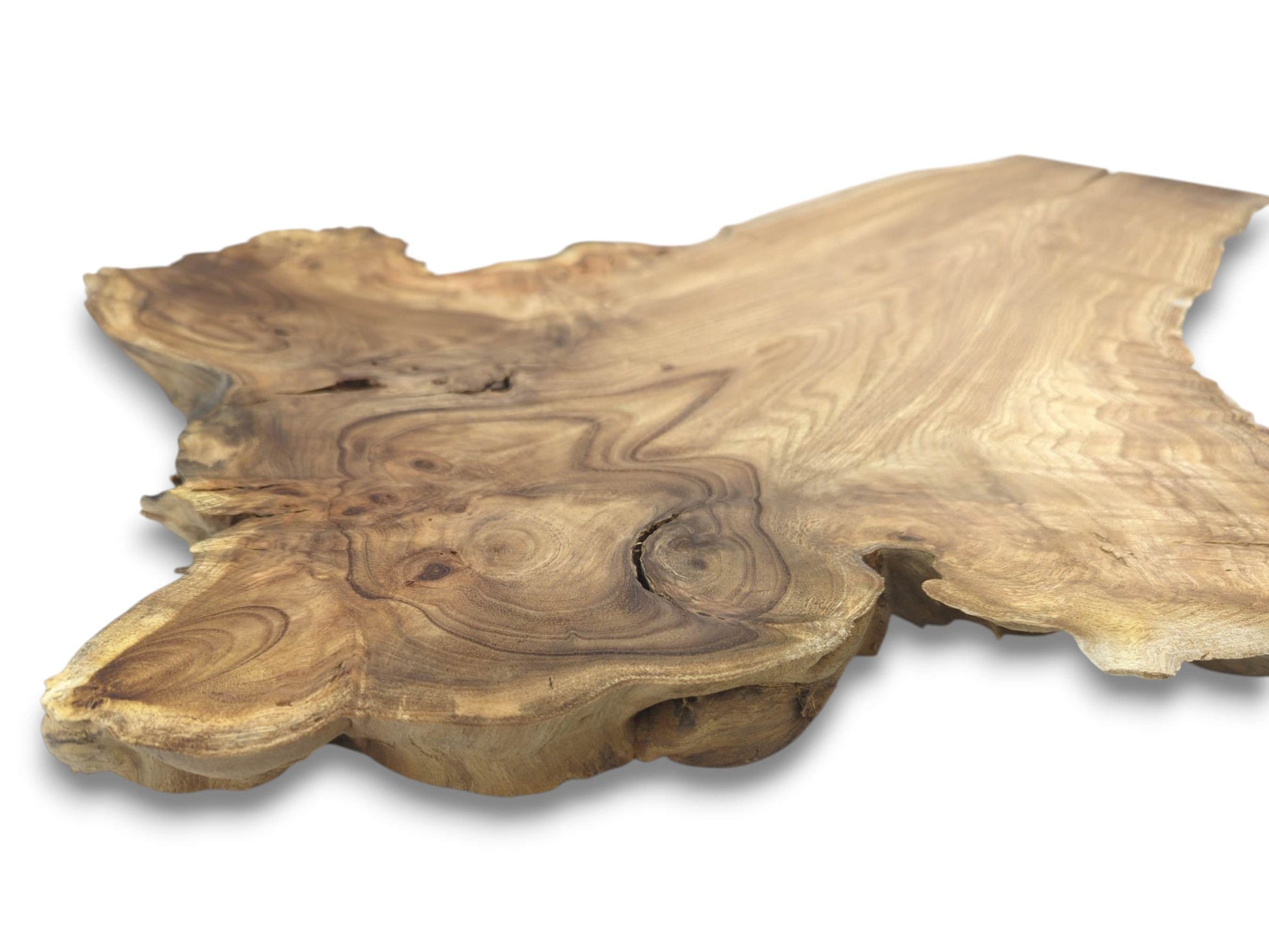 A thick lumber cross-section shows dark concentric grain rings surrounding a central natural fissure.