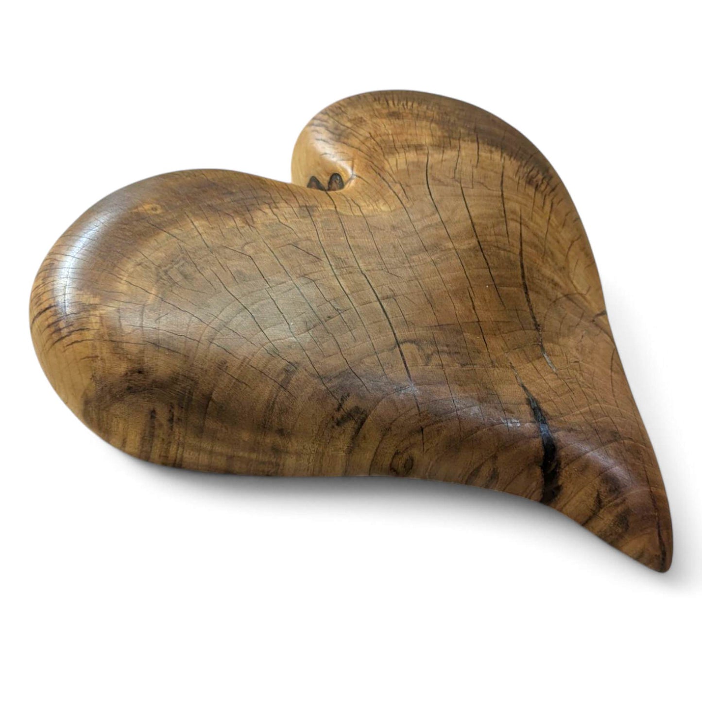 Hand-carved solid wooden heart, natural brown, with prominent grain and visible cracks, treated with oils.