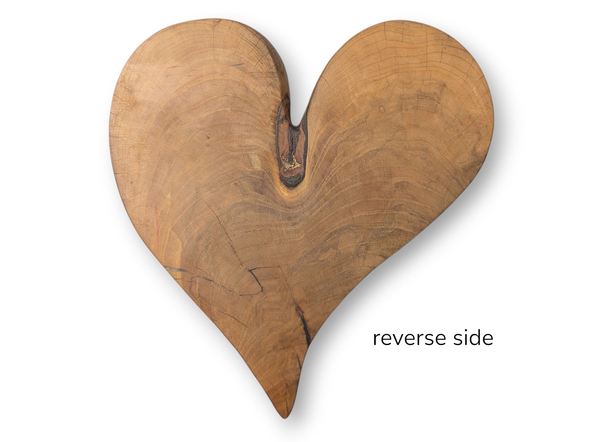 Heart-shaped natural wood sculpture, light brown, featuring distinct grain, visible cracks, and "reverse side" text.