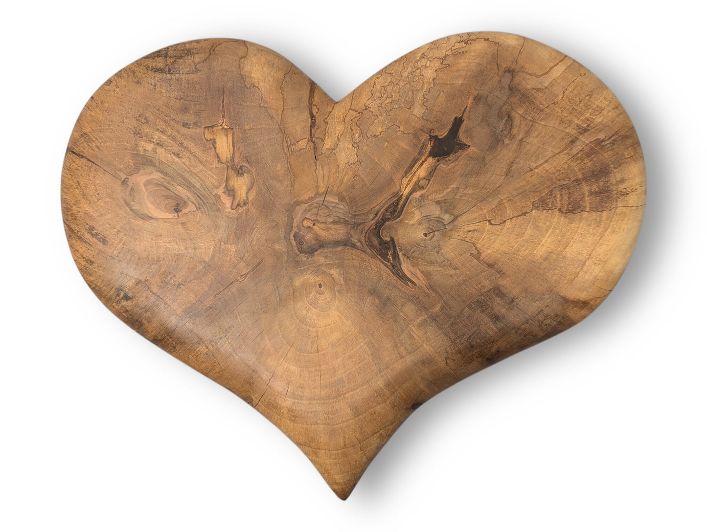 Heart-shaped hand-carved solid wood piece showing rich grain, prominent knots, and dark brown natural oil finish.