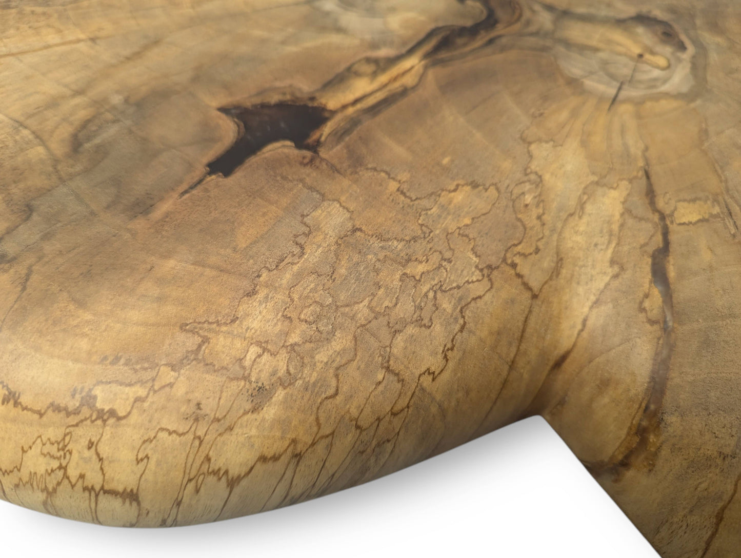 A textured detail view of light brown wood, displaying a dark knot, diverse grain, and unique dark patterns.