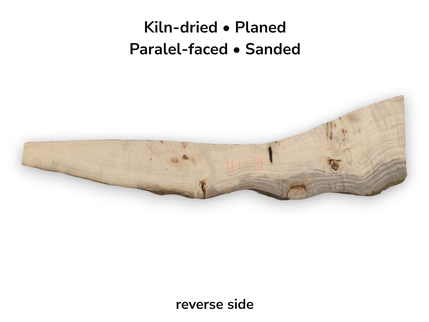The reverse of a poplar plank shows a dark mineral streak and orange crayon marking.