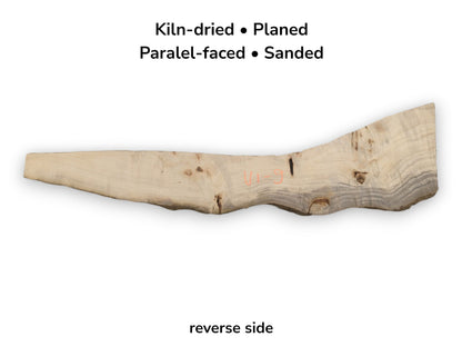 The reverse of a poplar plank shows a dark mineral streak and orange crayon marking.