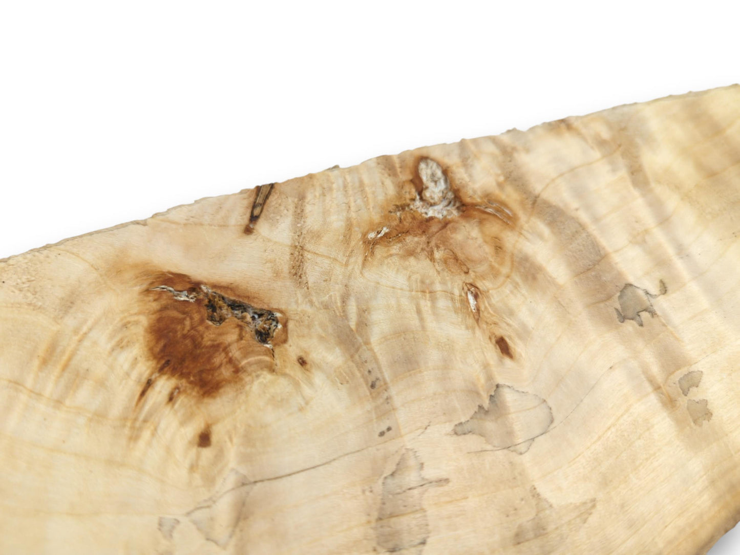 A dark, textured knot and a smaller burl interrupt the pale, swirling woodgrain.