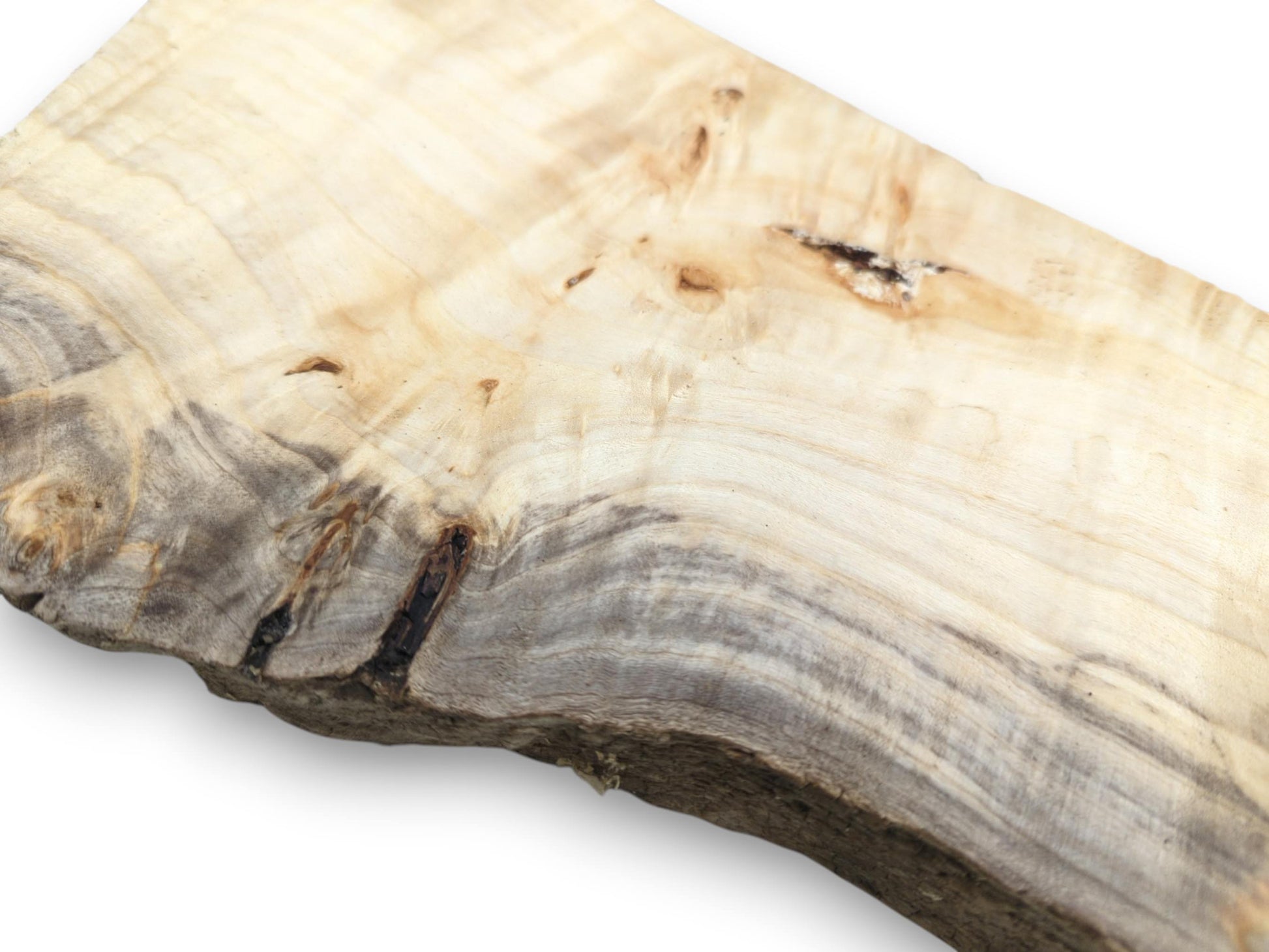 Dark, smoky figuring swirls across a pale plank, meeting a rough, natural live border.