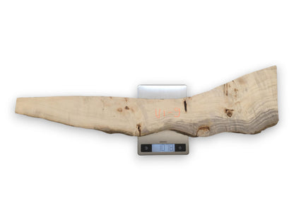 An overhead view shows a long, irregular wood plank with grey grain on a scale.