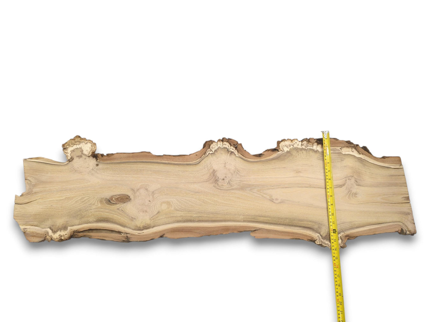 An overhead shot displays the full length of the live edge slab and its flowing grain.