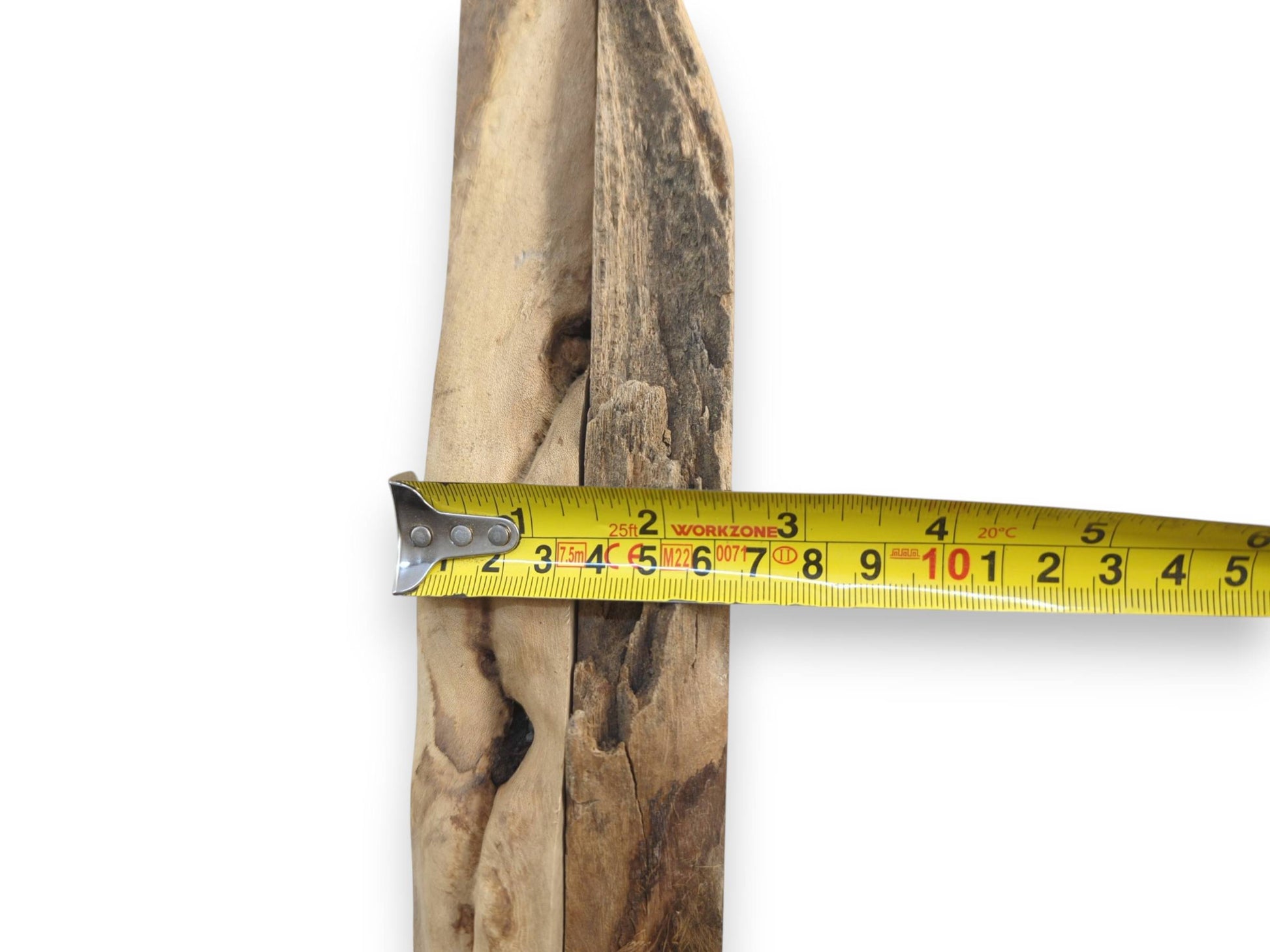 A yellow measuring tape across a natural wood piece, showing its width and rustic texture.