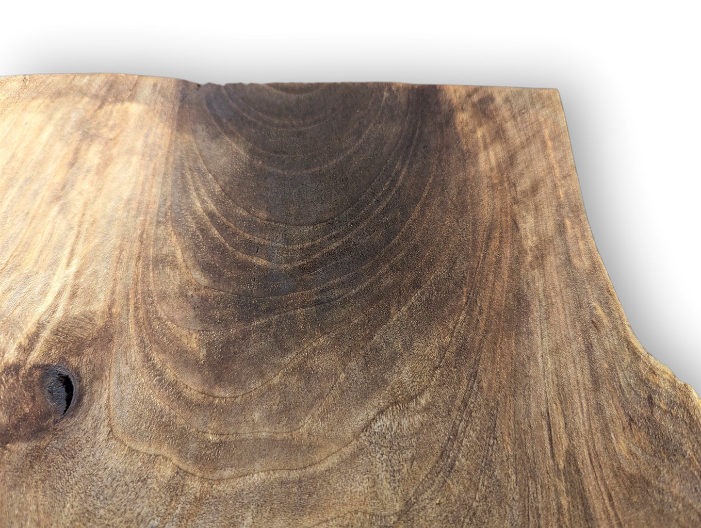 Walnut wood slice displaying varied dark and light brown grain patterns, distinct swirls, and a knot.