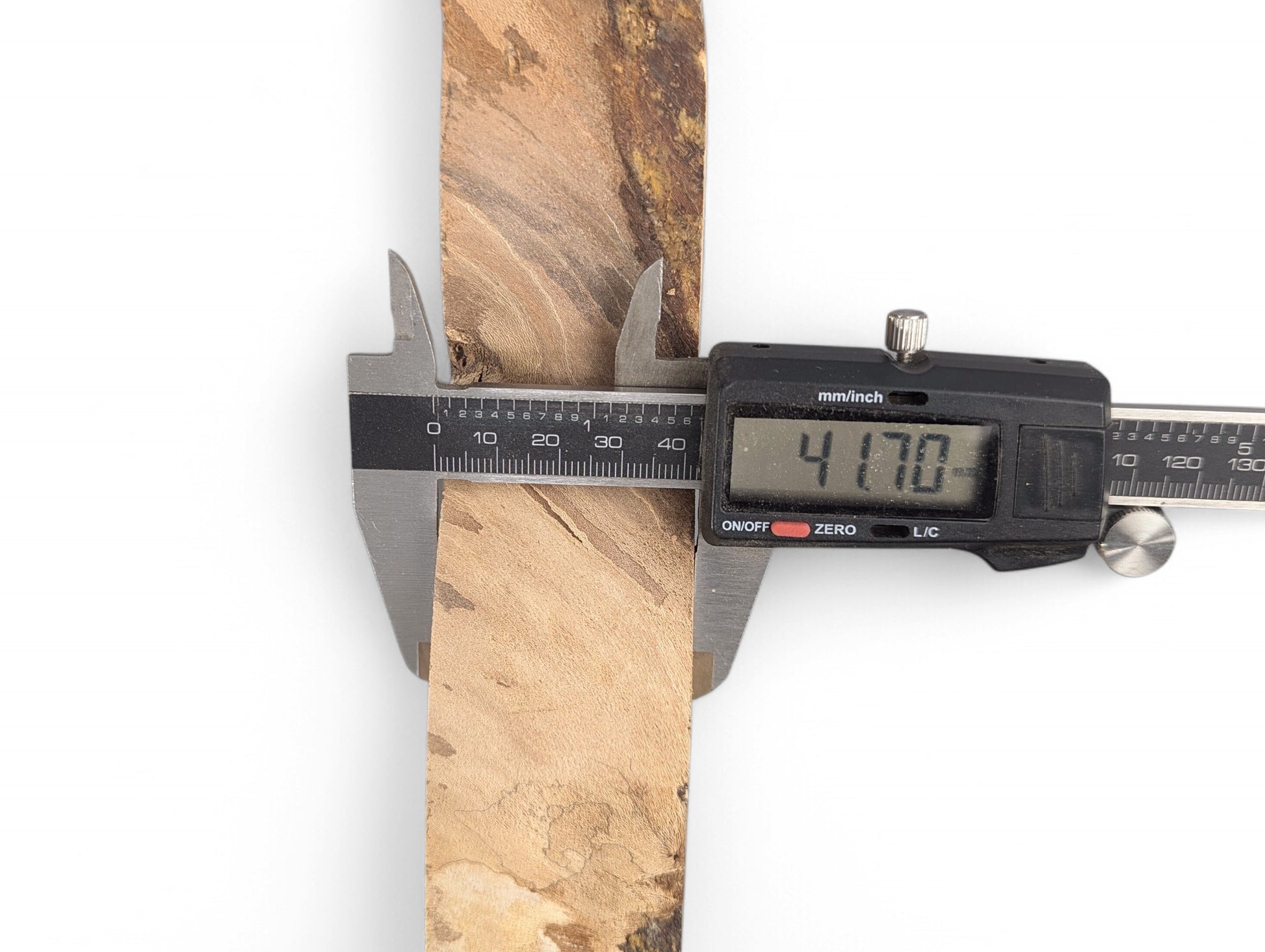 Digital caliper measuring a light brown, rectangular wood piece with natural grain, displaying 41.70mm.