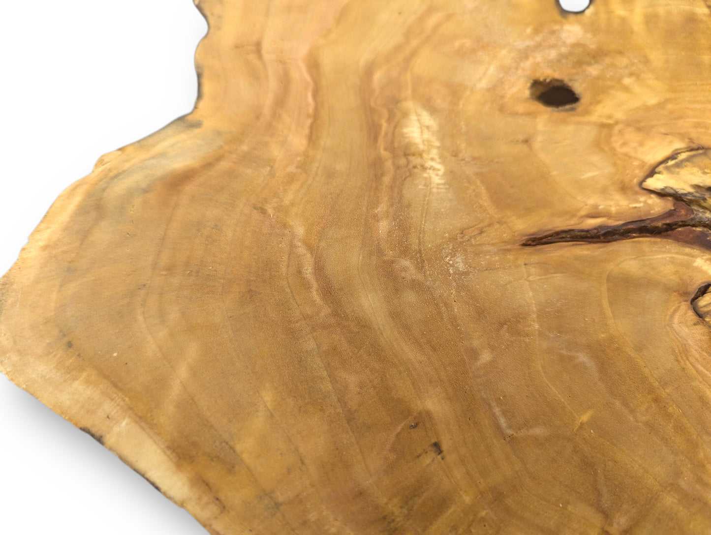 A light brown, irregular wood slice displays distinct growth rings, natural knots, and an organic live edge.