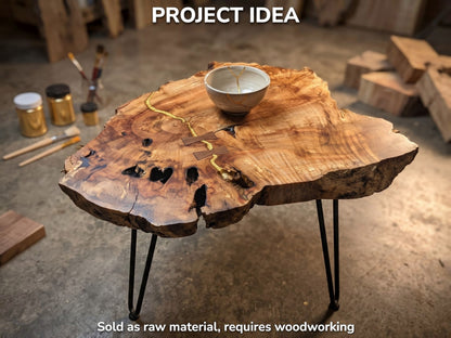 A live edge weeping willow wood slab with natural cracks filled with gold resin, on black legs.