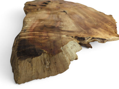 Angled view of a weeping willow wood slab with a live edge and natural grain.
