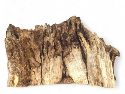 Irregularly shaped, weathered, untreated wood slab exhibiting dark bark and light, grooved wood textures.
