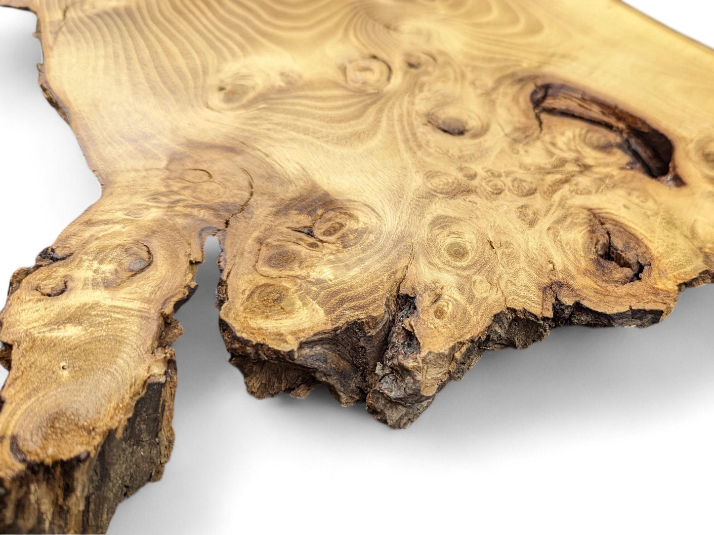 Close-up shows a golden brown black locust wood slice with intricate burls, swirling grain, and dark live edge.