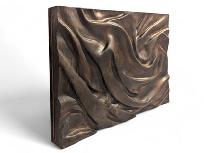 Rectangular solid walnut panel with dark brown, deeply carved fabric-like folds, finished with natural oils.