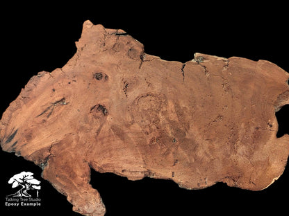 An irregular, reddish-brown weeping willow wood slab displays a rough, deeply fissured, decay-like texture.