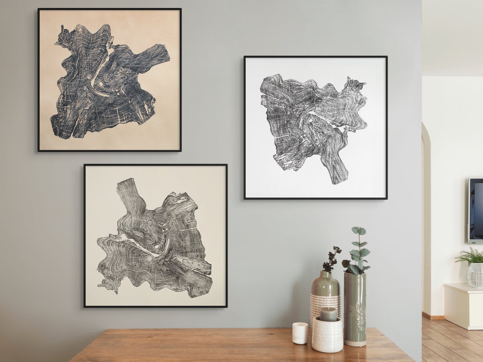 Three framed black tree root slice impressions with granular patterns on cream and white paper.