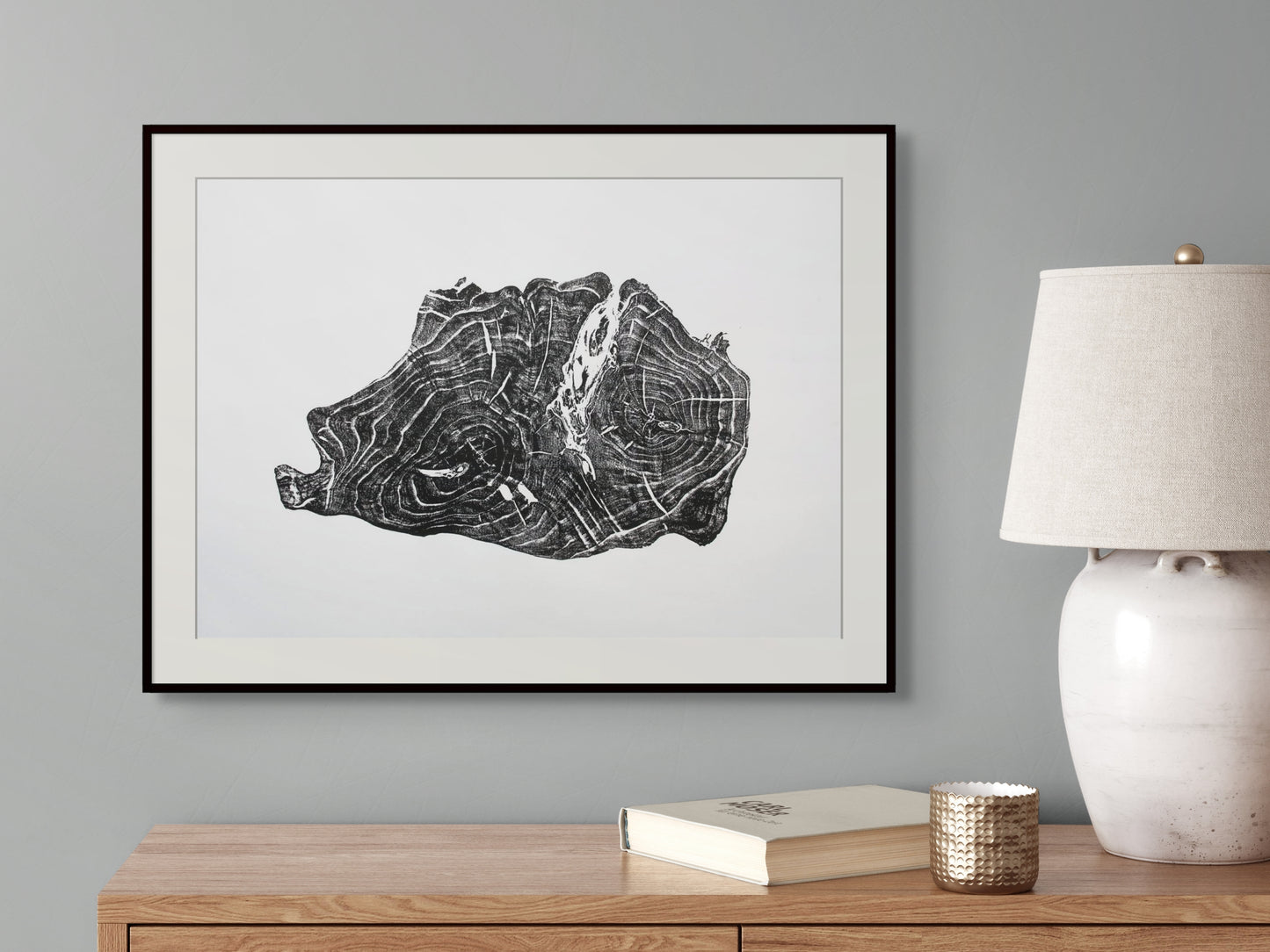 Black and white framed art print depicting an irregular tree root slice with growth rings.