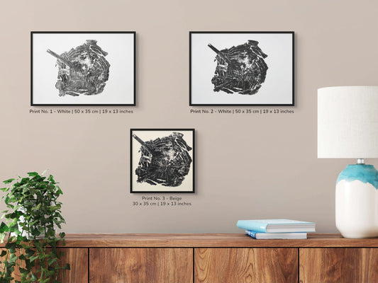 Image features three framed black woodcut tree root prints with text, a plant, lamp, and books.